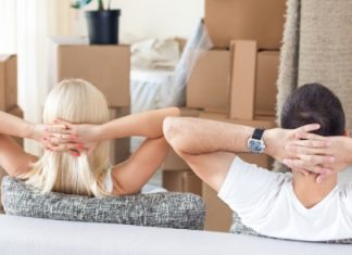 couple assis devant cartons de déménagement